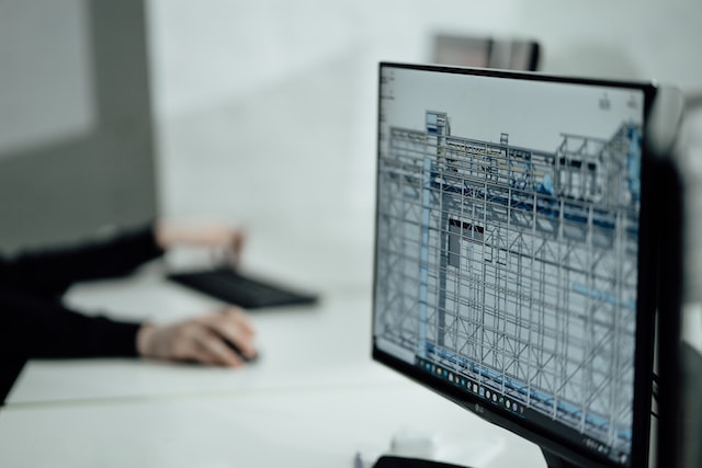 Computer monitor displaying CAD model of a structure.