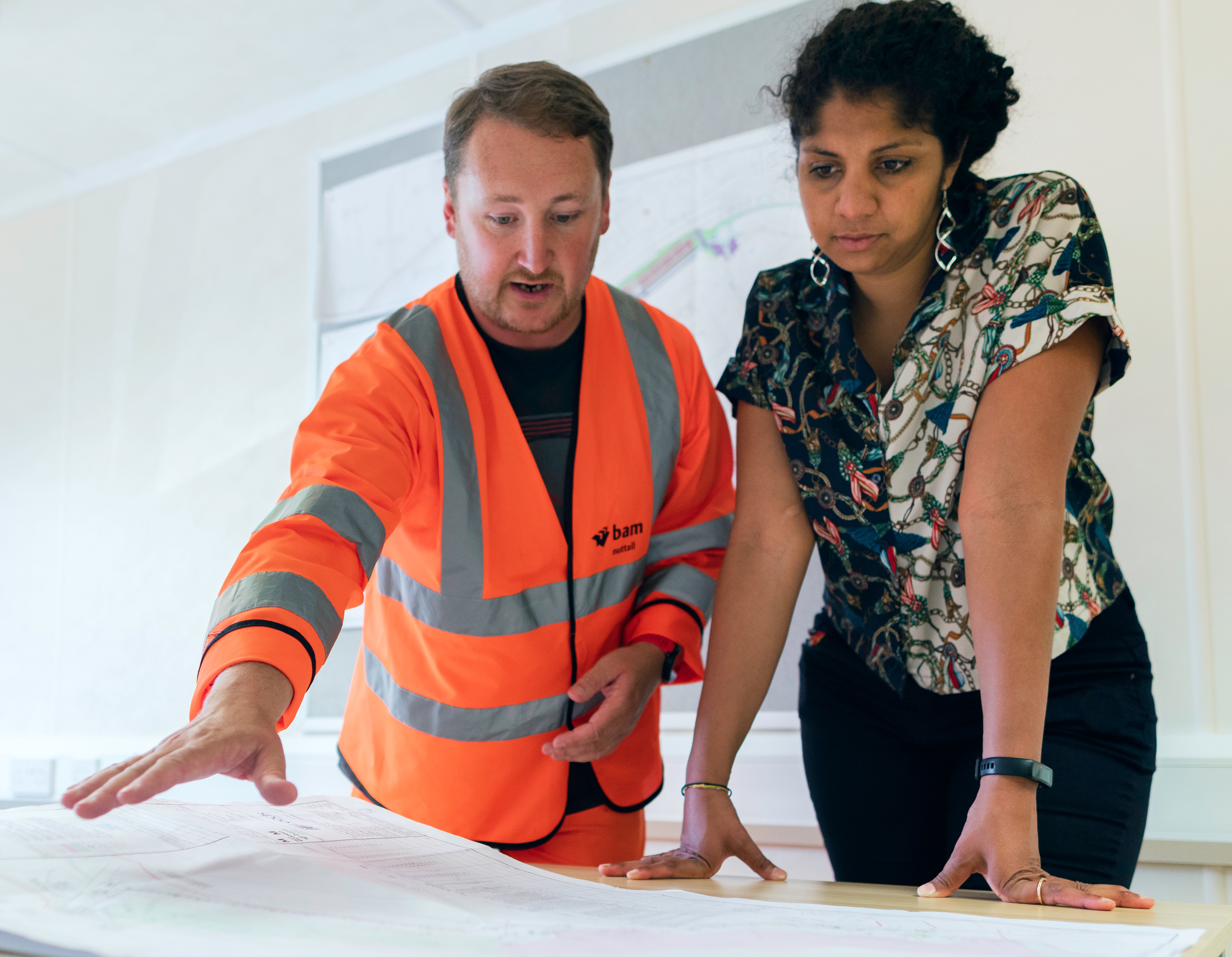 Two people reviewing engineering plans. (Photo by ThisisEngingeering Raeng, Unsplash)